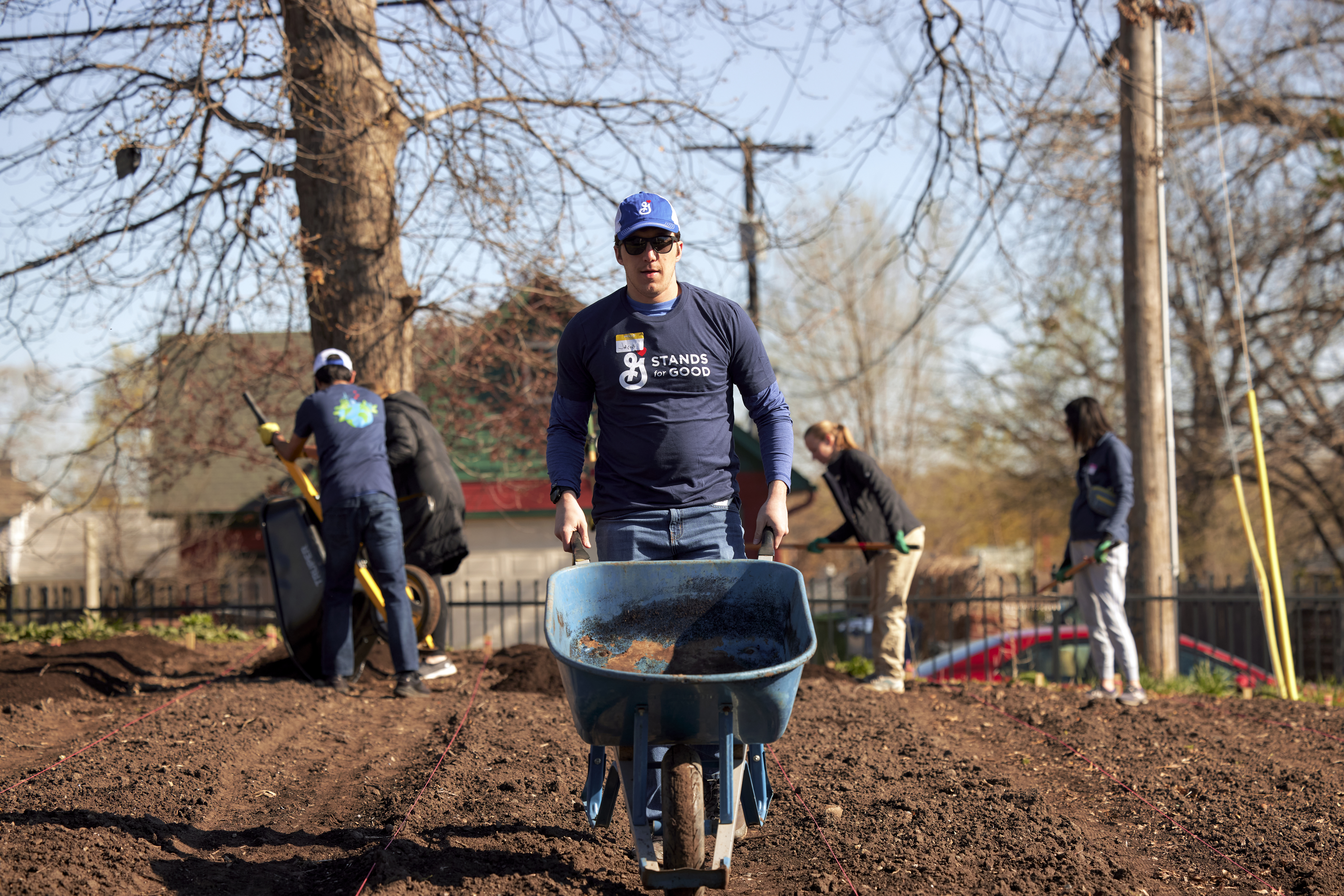 Volunteer pushing wheelbarrow